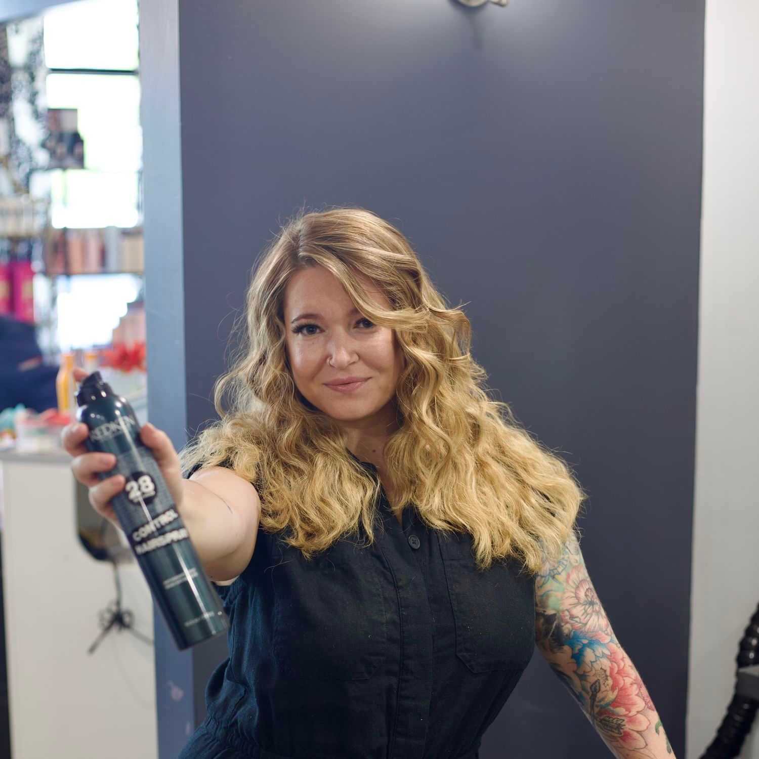 Portrait of Ariel, a professional stylist at Illusions Salon & Spa, showcasing their expertise and style.