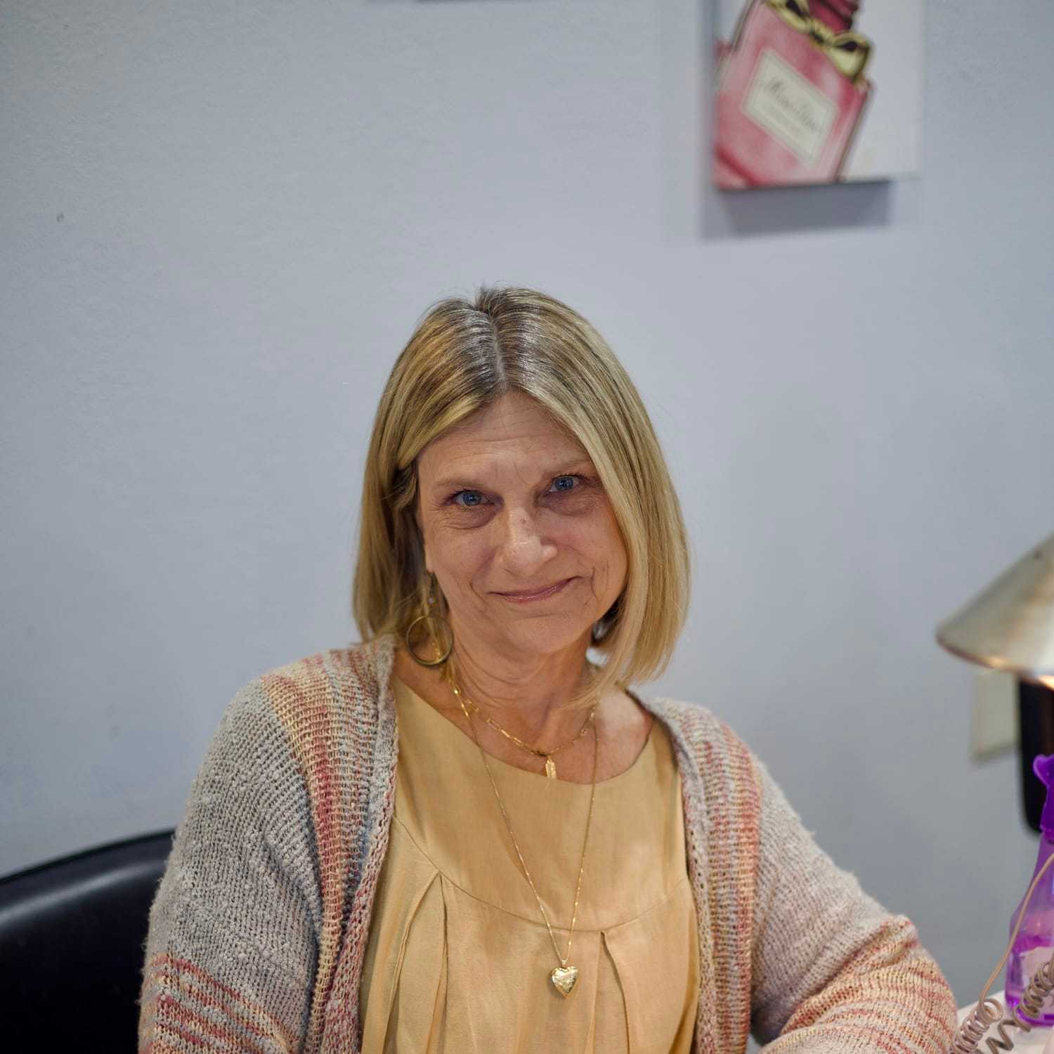 Portrait of Michelle, a professional stylist at Illusions Salon & Spa, showcasing their expertise and style.