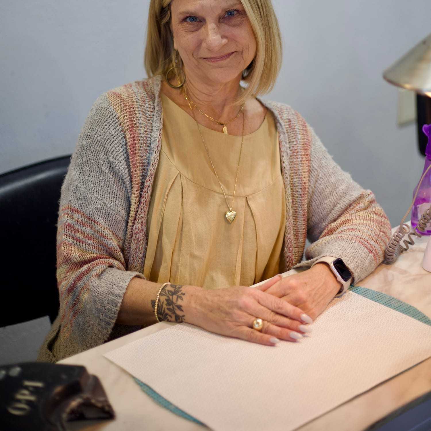 Portrait of Michele, a professional stylist at Illusions Salon & Spa, showcasing their expertise and style.