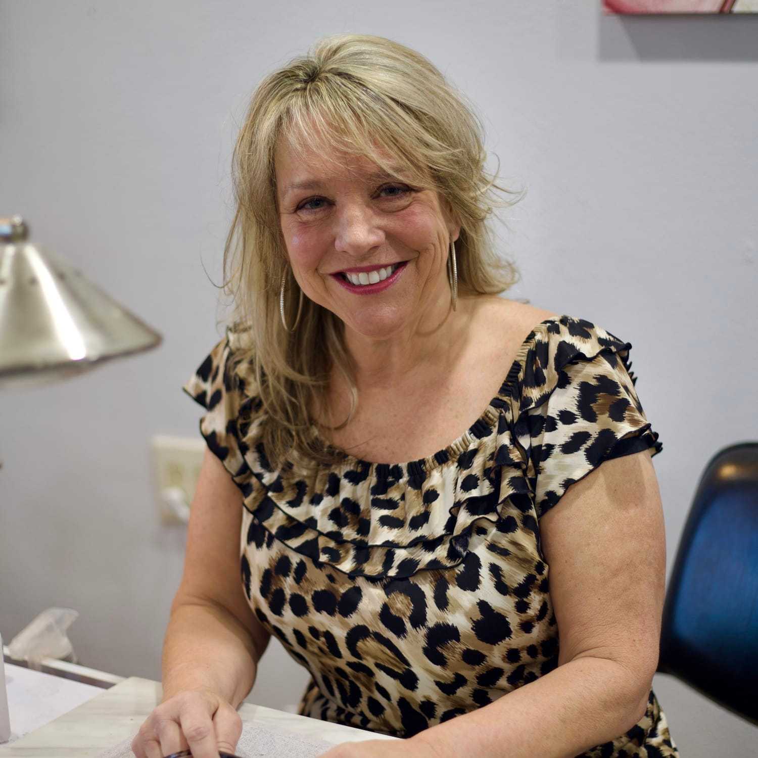 Portrait of Kim, a professional stylist at Illusions Salon & Spa, showcasing their expertise and style.