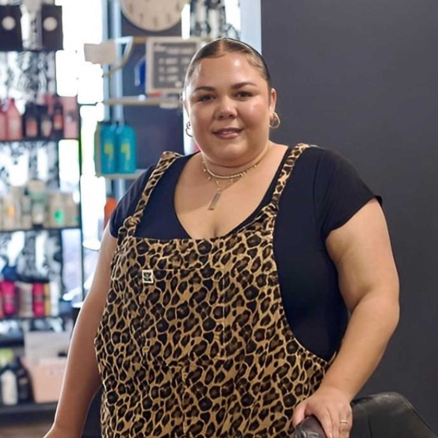 Portrait of Korine, a professional stylist at Illusions Salon & Spa, showcasing their expertise and style.