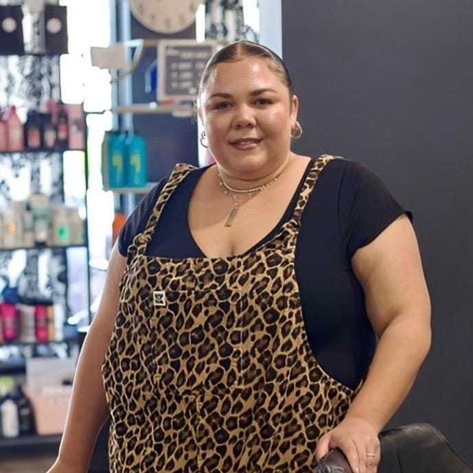 Portrait of Korine, a professional stylist at Illusions Salon & Spa, showcasing their expertise and style.